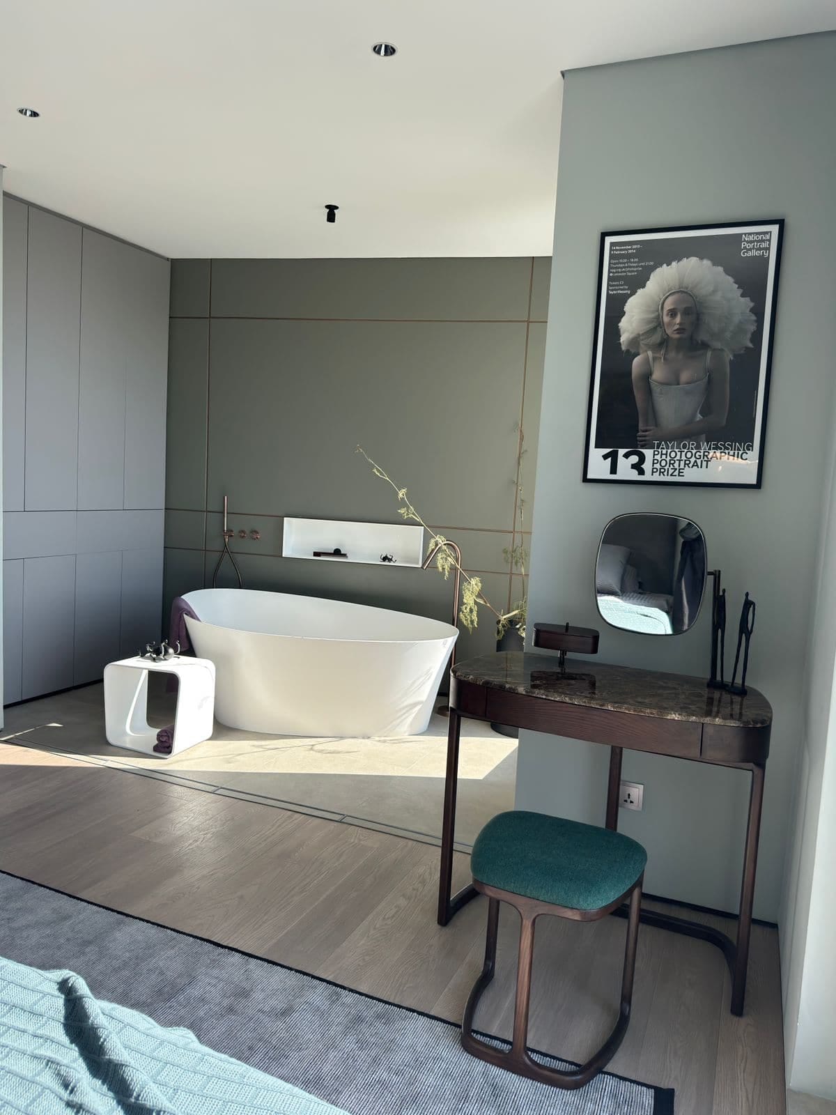Bedroom with a freestanding bathtub and vanity table in a villa in Blizikuće, Montenegro. Modern interior design.