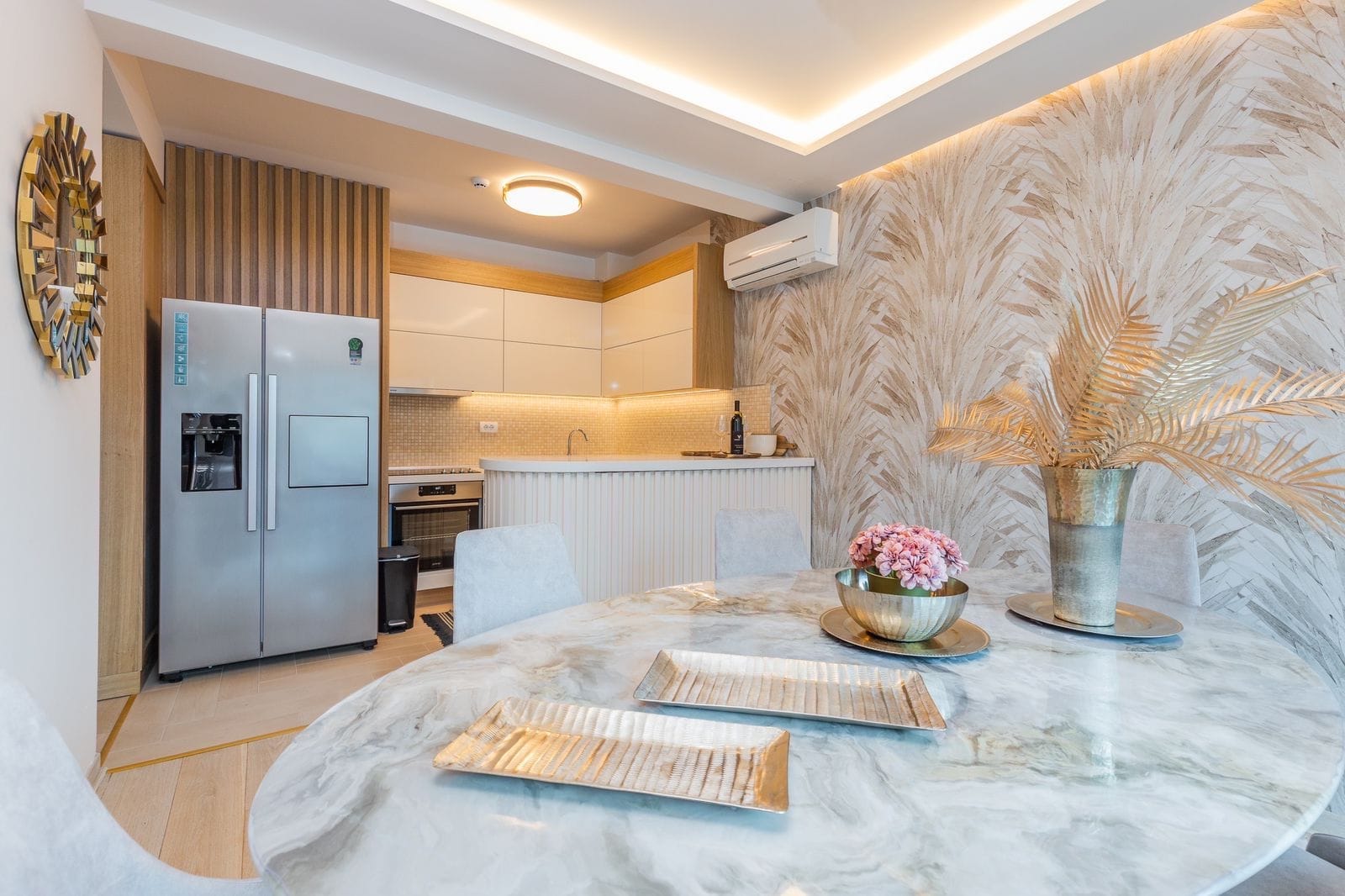 Modern kitchen-dining room in a penthouse, Pržno, Montenegro: marble table, stylish cabinetry, and interior decor.