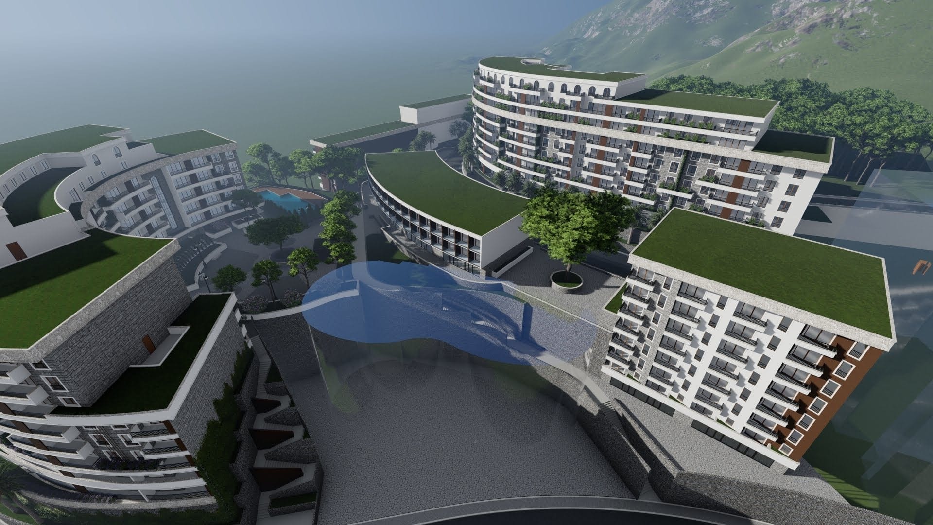 Aerial view of a modern residential complex in Becici, Montenegro: multi-story buildings, green roofs, and a swimming pool.