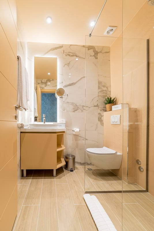 Modern bathroom with a shower cabin and marble-style finishes in a hotel in Budva, Montenegro.