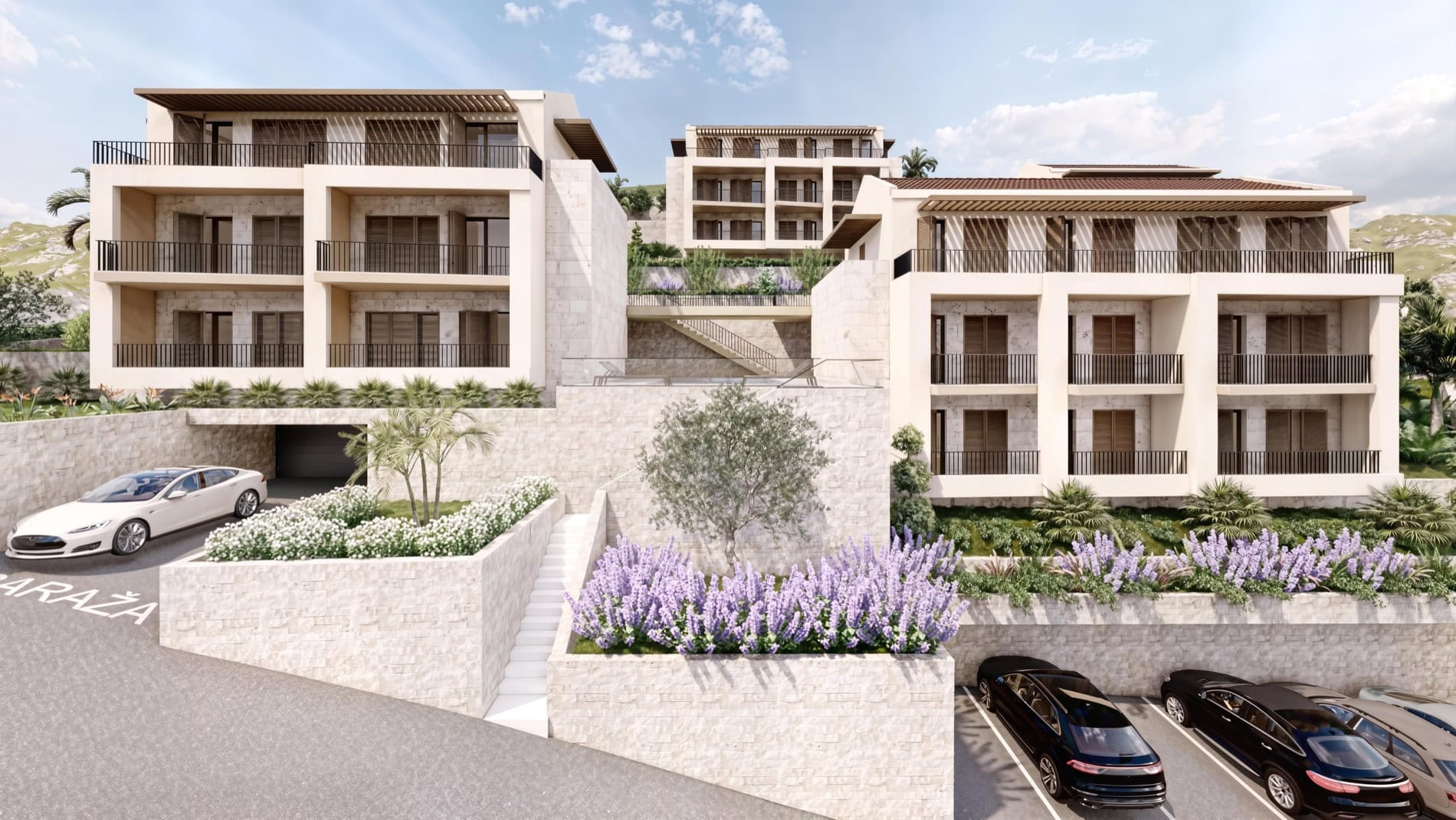 Modern residential complex in Muo, Montenegro: multi-level buildings with stone finishes, terraces, and parking.