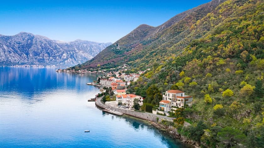 Three-story villa in Stoliv, Montenegro: panoramic view of the Bay of Kotor, mountains, and coastal architecture.