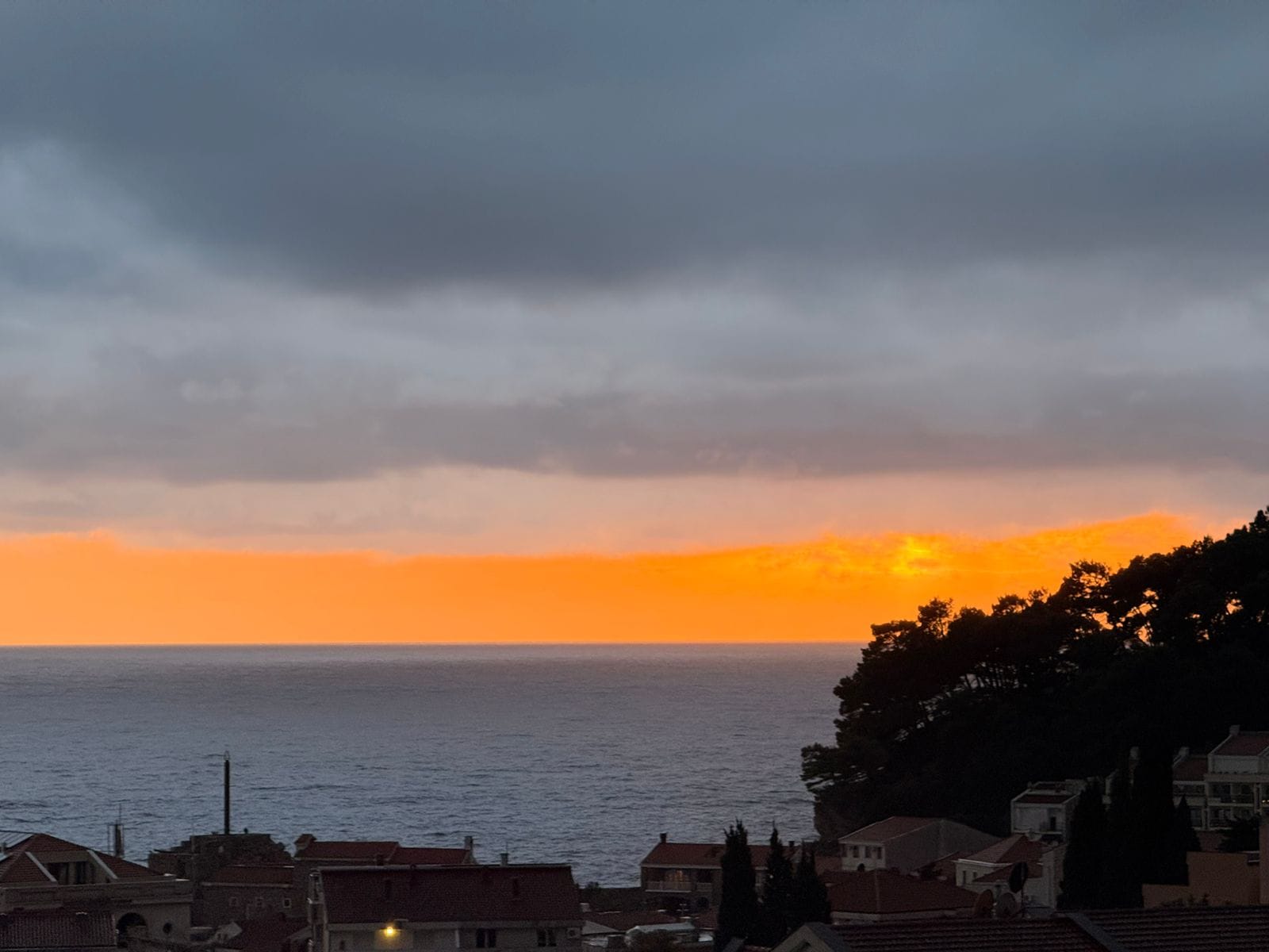 Panoramic sunset view over the sea and the city of Petrovac in Montenegro from apartment No. 2176
