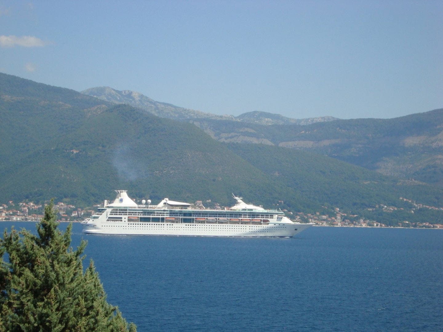 View of a cruise ship in Kotor Bay from a house in Krašići, Montenegro: a panorama of the sea and mountains.