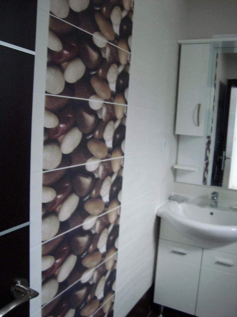 Modern bathroom with sea pebble decor in a house for sale, Krašići, Montenegro.