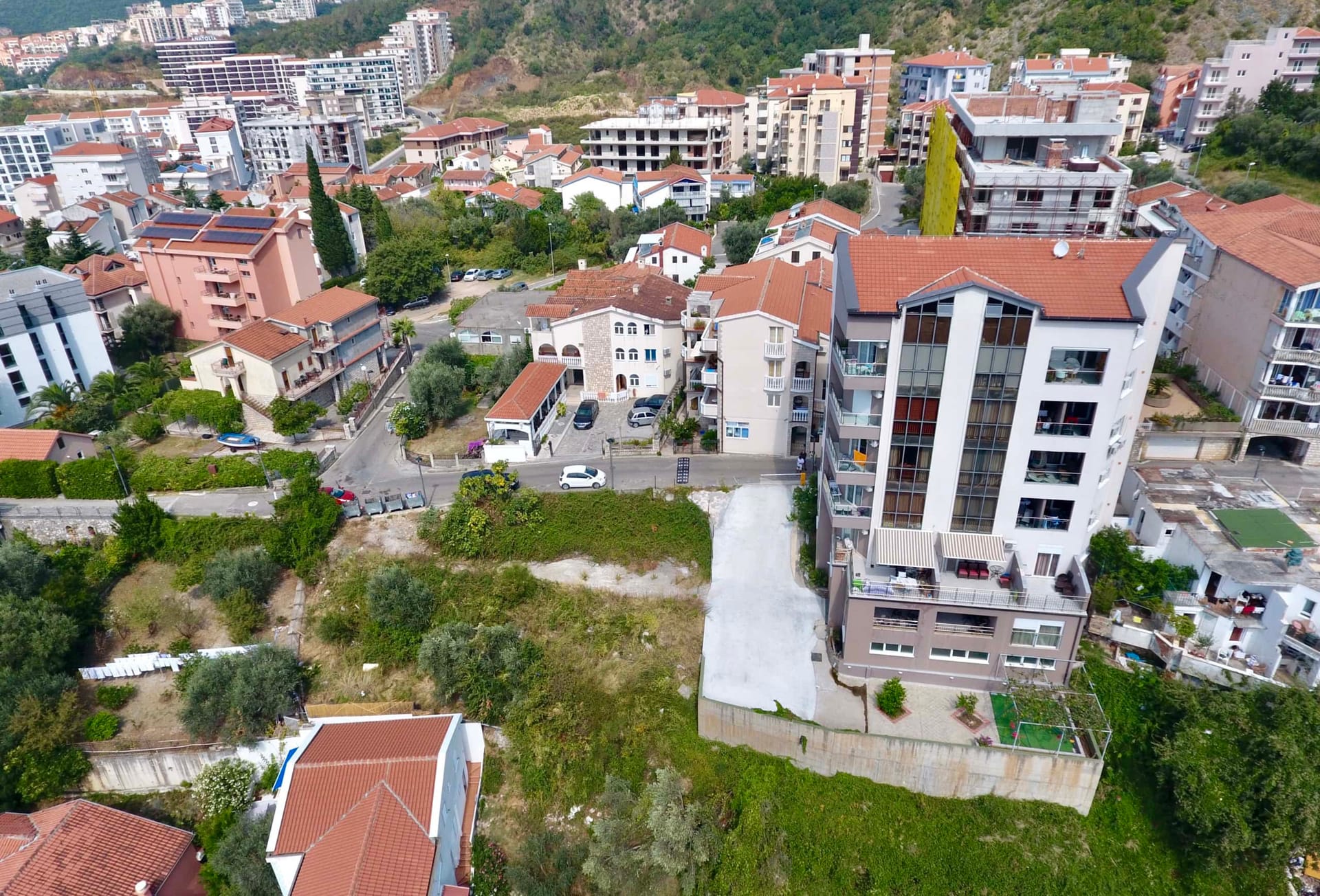Aerial view of a land plot and residential complex in Bečići, Rafailovići, Montenegro: panorama of the area and development.