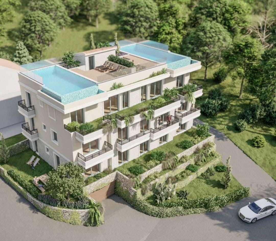 Residential complex in Dobrota, Montenegro: a modern building with terraces, landscaping, and rooftop pools.