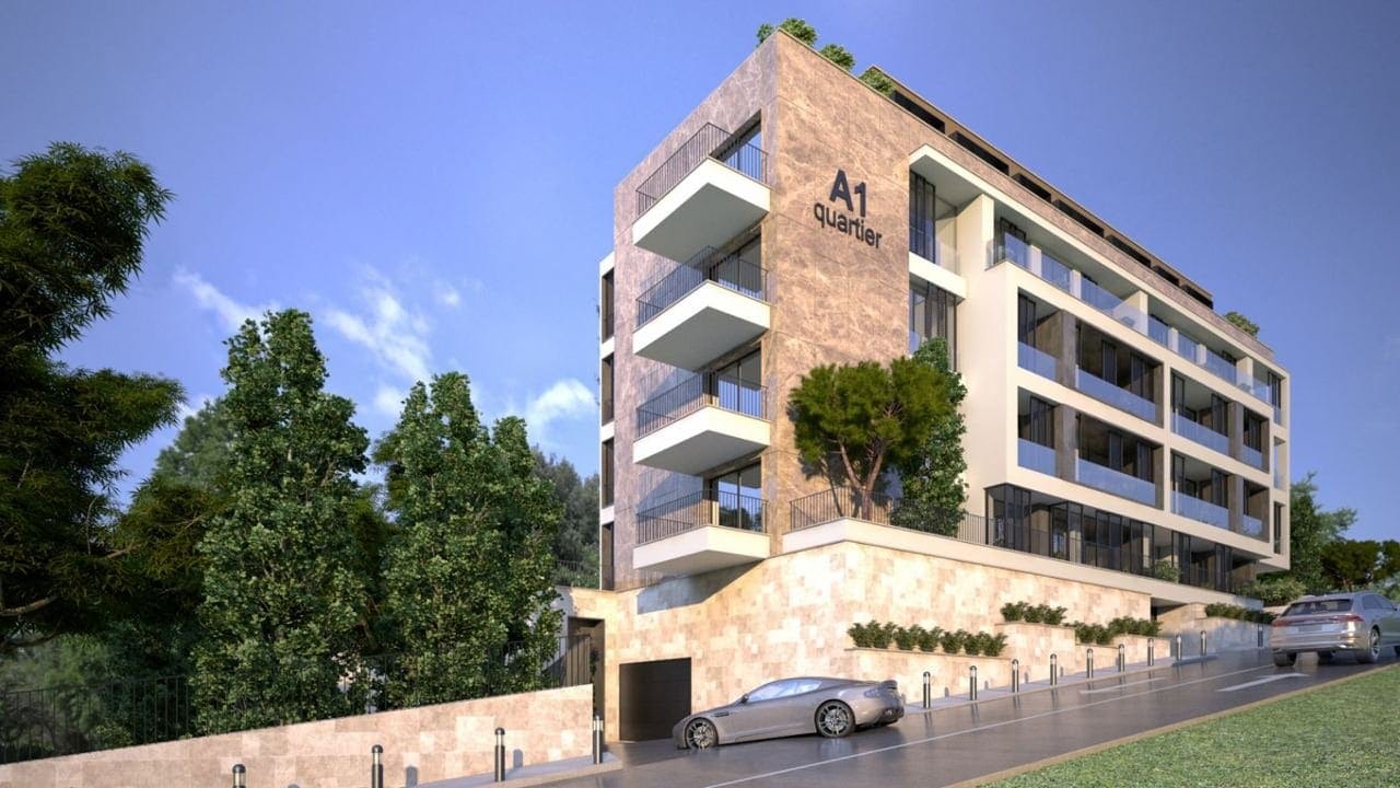 Modern residential complex A1 Quartier in Budva, Montenegro: facade with stone cladding, balconies, and parking.
