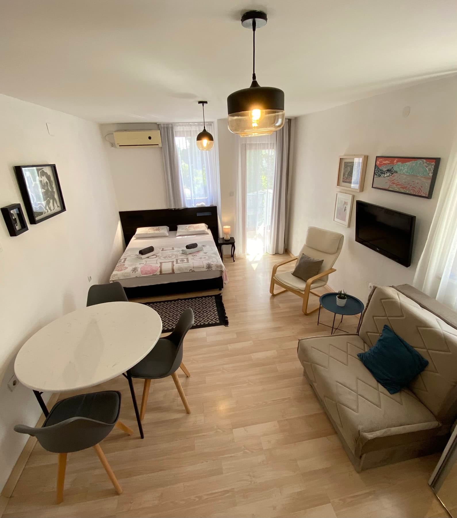 Cozy bedroom with a double bed and seating area in a house, Shushan, Montenegro: modern furniture and a bright interior.