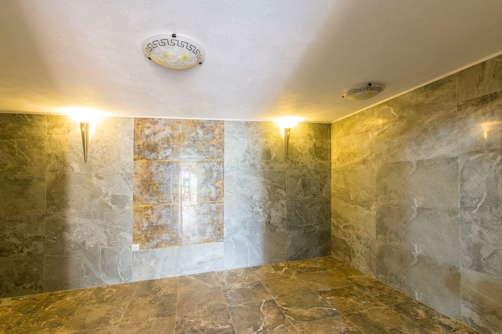 Villa interior in Krašići, Montenegro: marble-look porcelain tile wall and floor finishes, designer lighting.