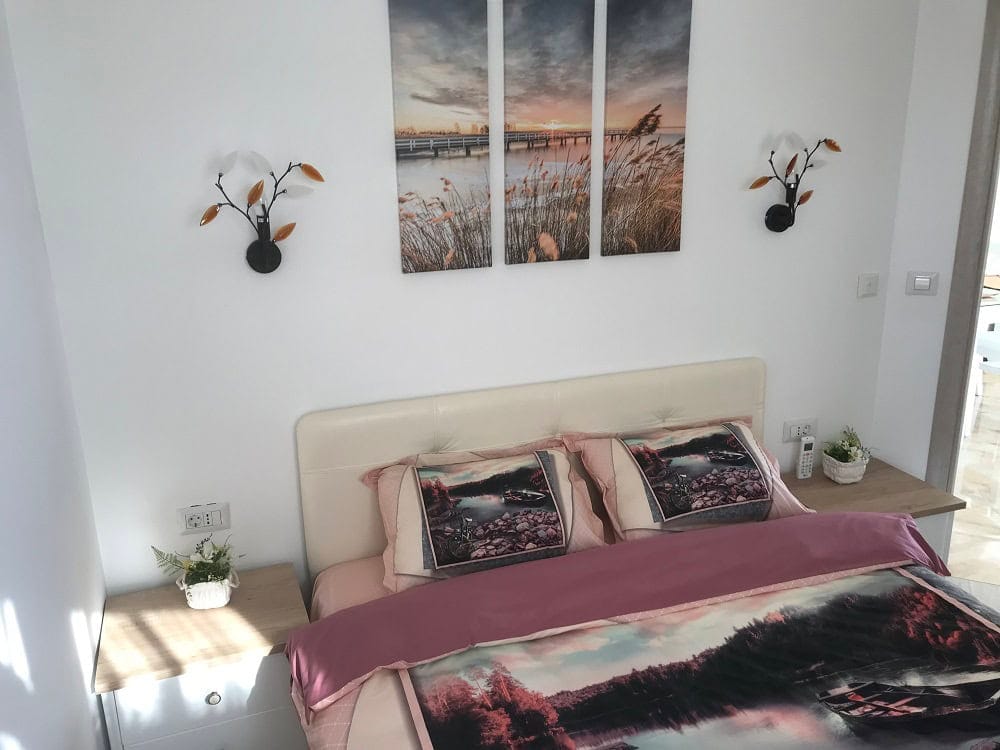 Cozy bedroom with a double bed in an apartment in Dobri Vody, Montenegro: modern interior and decor.
