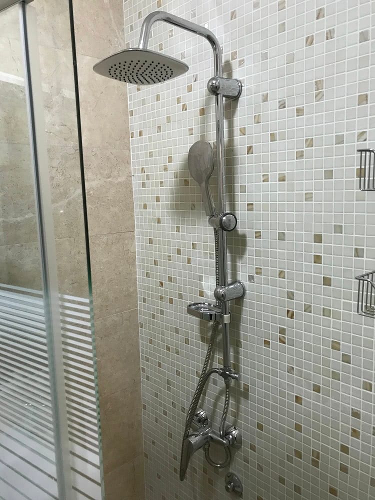 Modern shower cabin with a rain shower in the bathroom of an apartment in Dobri Vody, Montenegro.