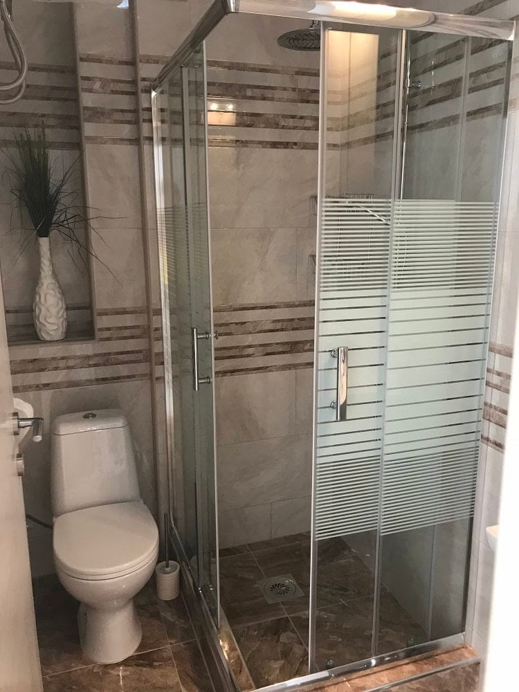 Modern bathroom with a shower cabin and tiled finishes in an apartment, Dobri Vody, Montenegro.