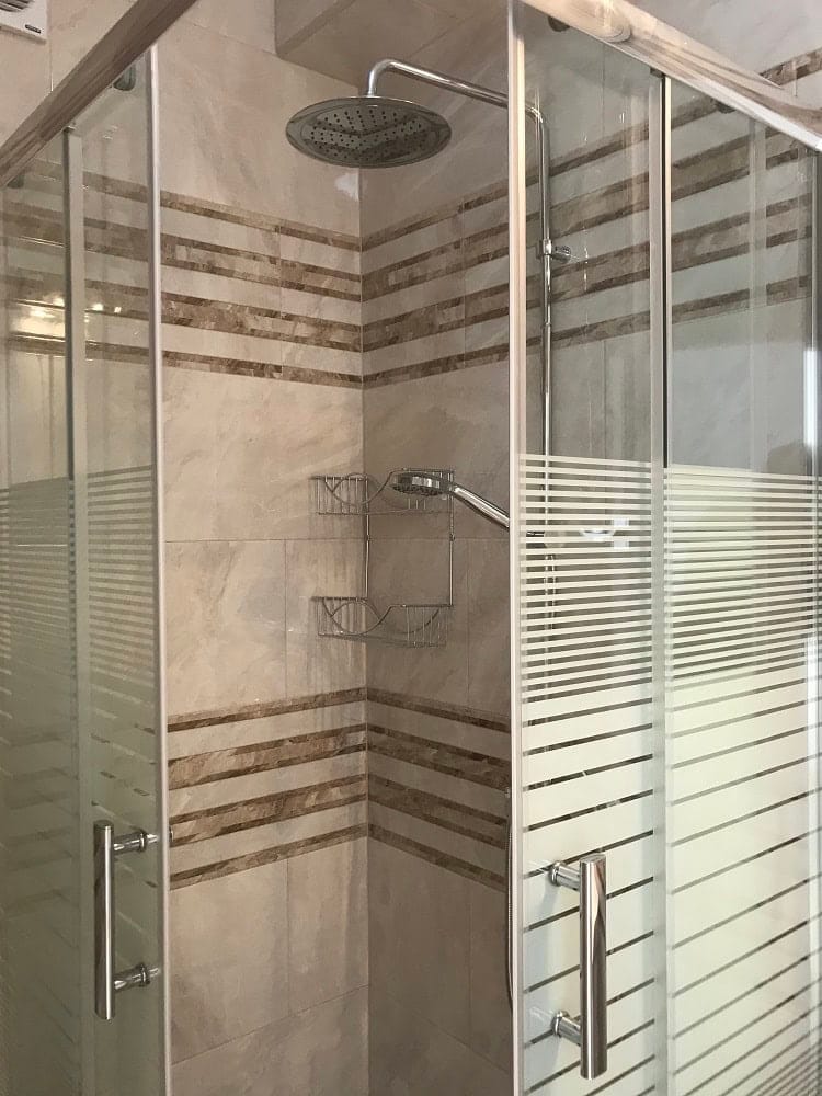 Modern shower cabin with a rain shower in the bathroom of an apartment in Dobri Vody, Montenegro.
