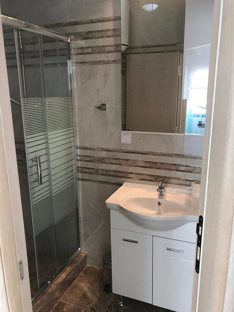 Modern bathroom with a shower cabin and vanity in an apartment, Dobri Vody, Montenegro.