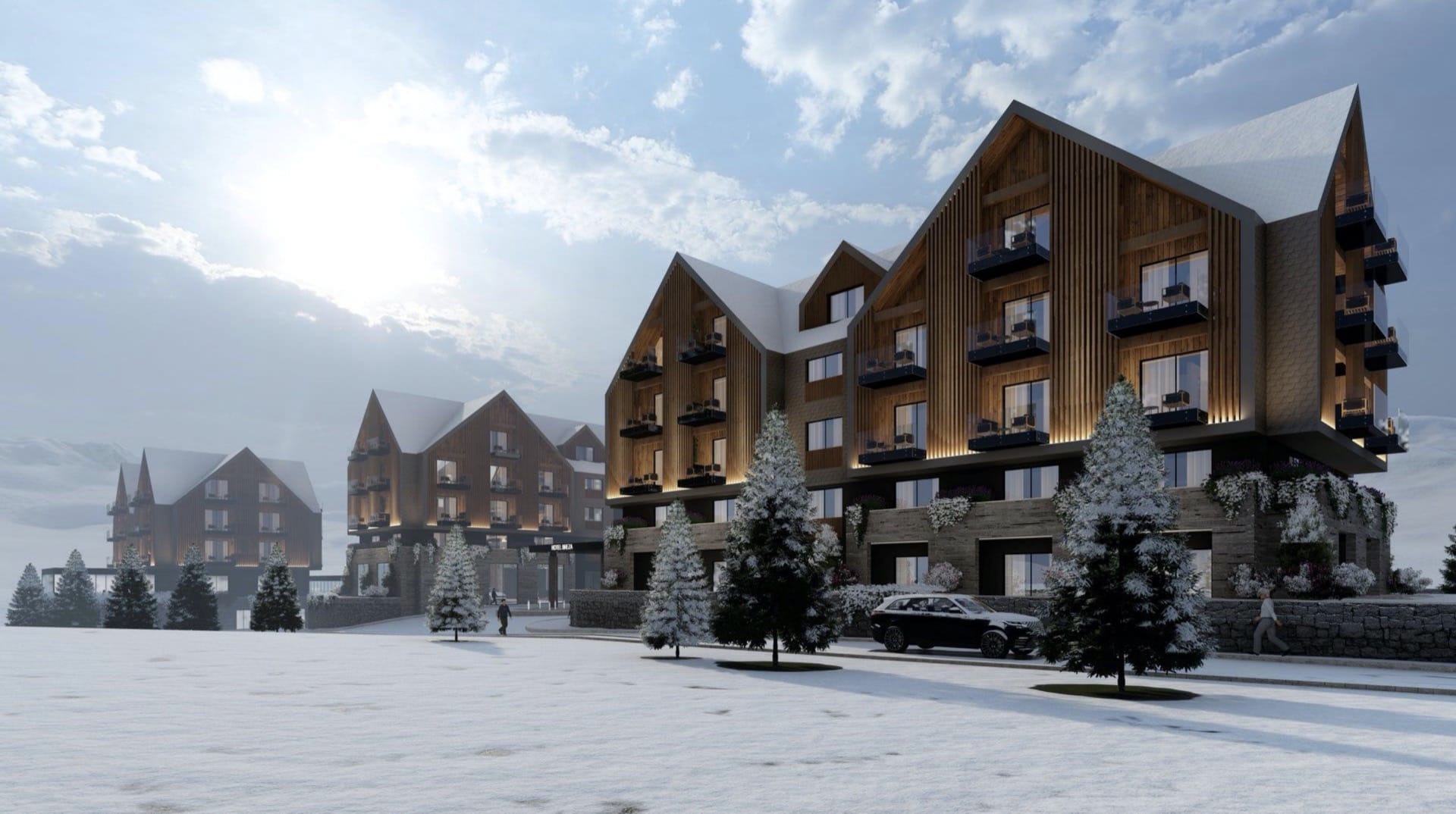 Modern chalet-style hotel in Kolašin, Montenegro: wooden facade, panoramic balconies, and snow-covered grounds.
