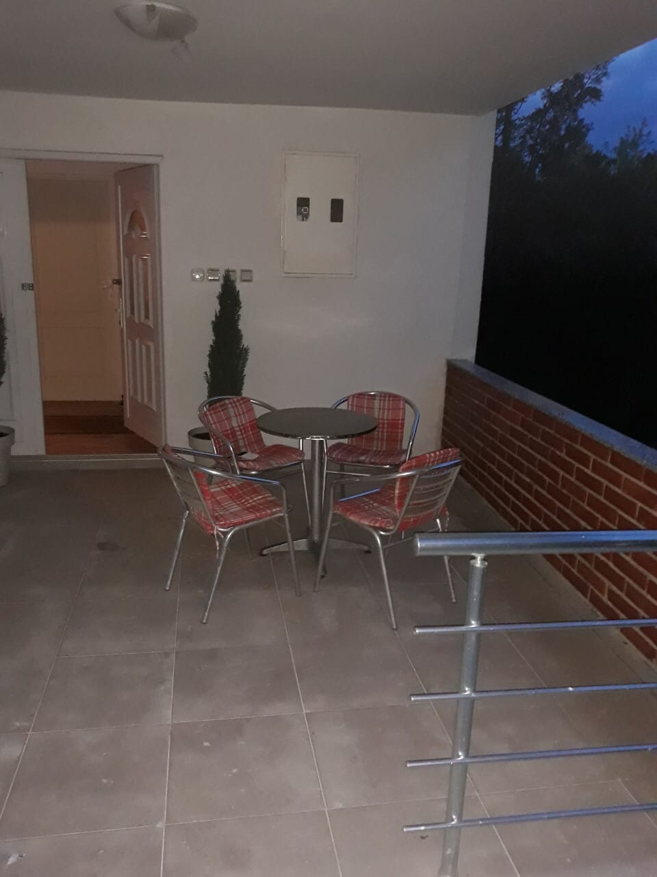 Cozy terrace with a dining area and brick railing in a house at the Žanjic resort, Montenegro.