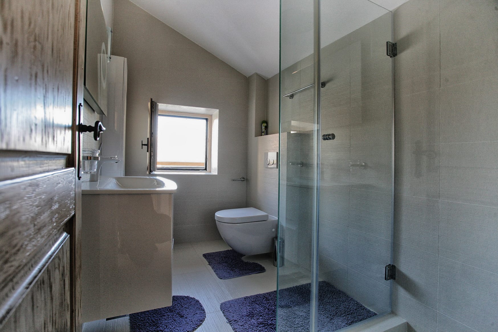 Modern bathroom with a shower cabin and light finishes in a villa in Reževići, Montenegro.