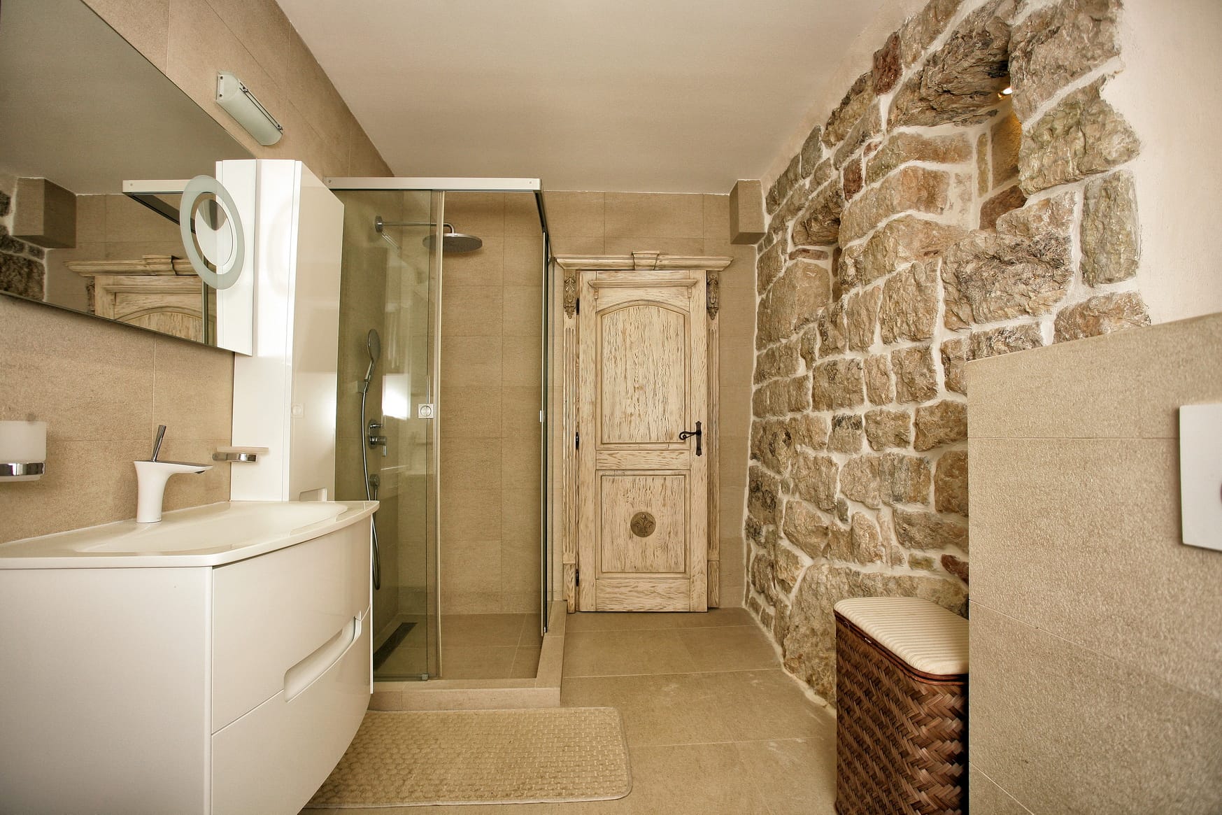 Modern bathroom with a shower cabin and natural stone finishes in a villa in Reževići, Montenegro.