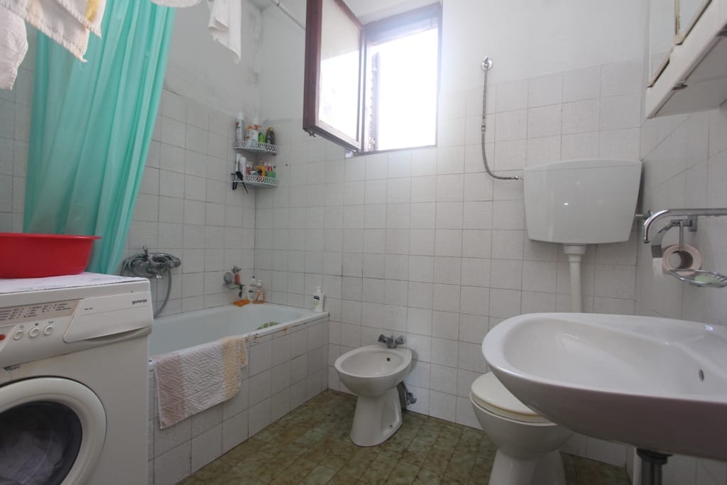 Bathroom in a house in Orahovac, Montenegro: tile, bathtub, bidet, sink, and Gorenje washing machine.