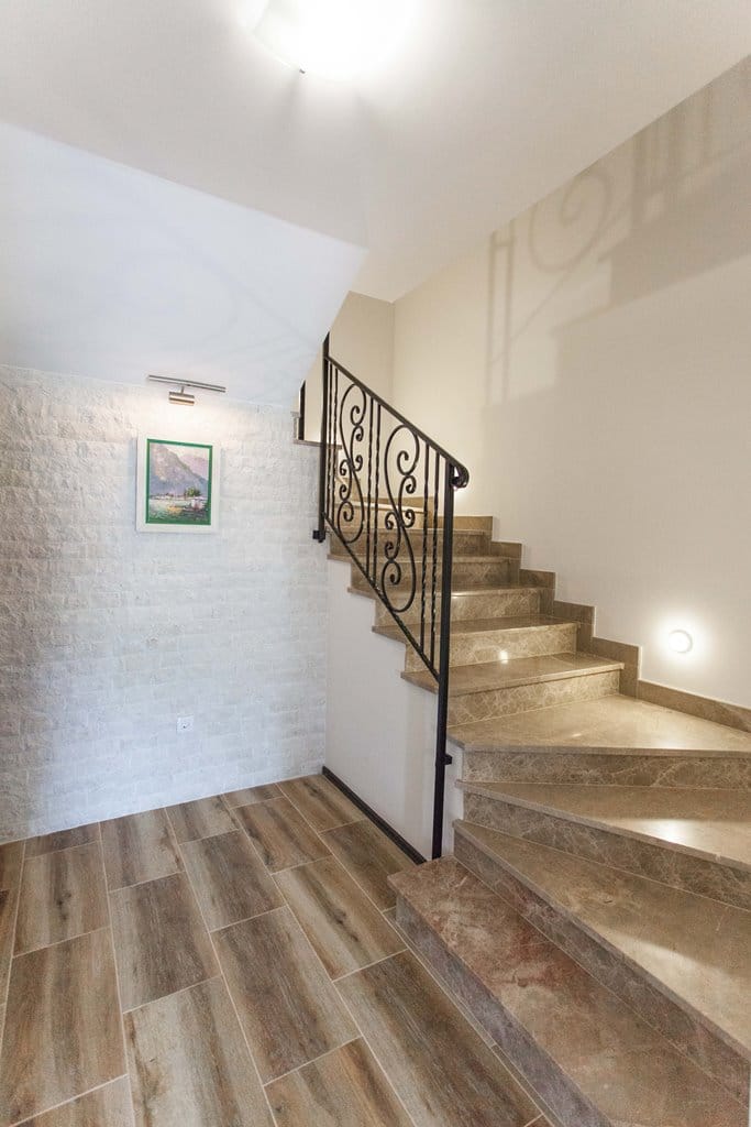 Staircase with marble steps and wrought-iron railings in an apartment interior, Kamenovo, Montenegro.