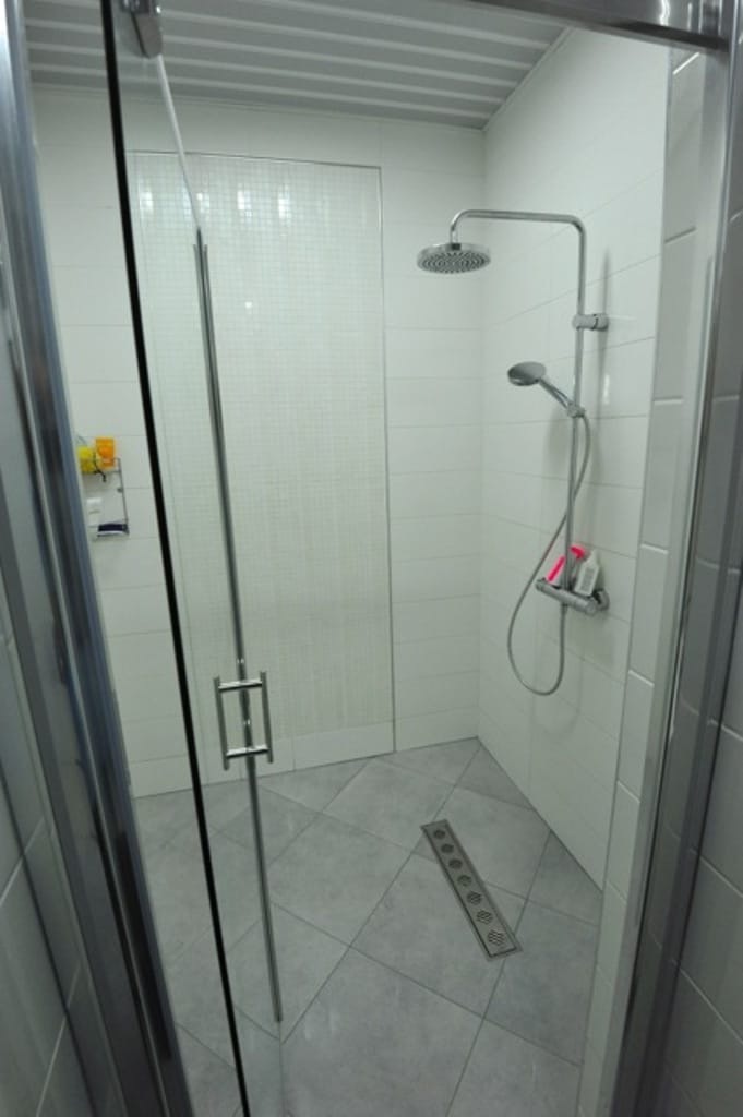 Modern shower cabin with a rain shower in the bathroom of an apartment in Dobri Vody, Montenegro.