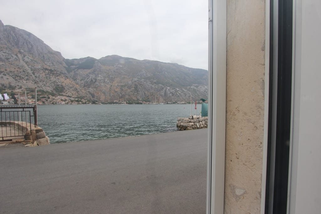 View of the Bay of Kotor and the mountains from a house in Muo, Montenegro: waterfront, pier, and panoramic sea view.