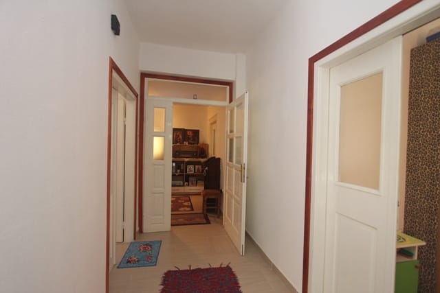 Bright hallway with white interior doors in a house in Muo, Montenegro, view of a furnished living room.