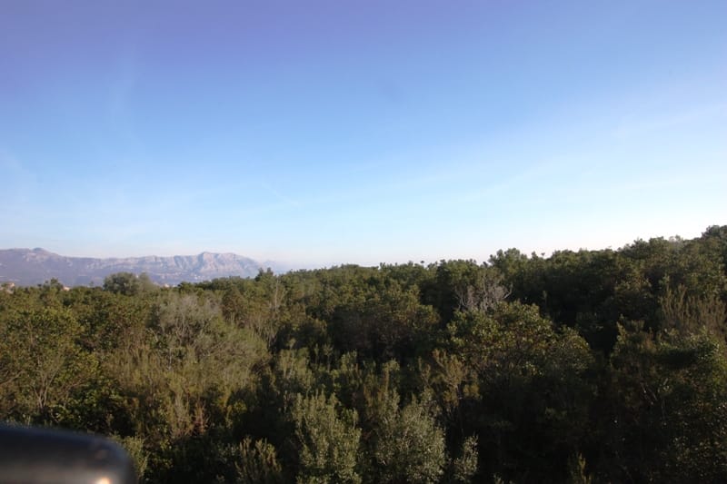 Panoramic view of a green forested area and mountains from a plot of land in the village of Krimovica, Montenegro.