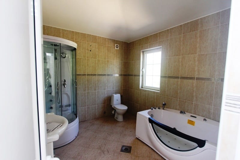 Bathroom with a jacuzzi and shower cabin in a villa in Dobra Voda, Montenegro: modern tile finish.