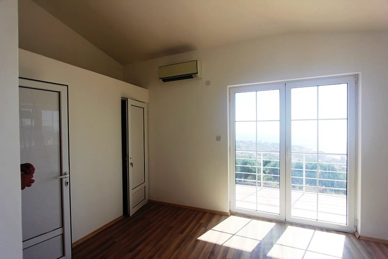 Bright bedroom with panoramic access to the terrace and sea view in a villa, Dobri Vody, Montenegro.