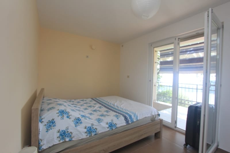 Bright bedroom with a double bed and access to the balcony in a house, Seoce, Montenegro.