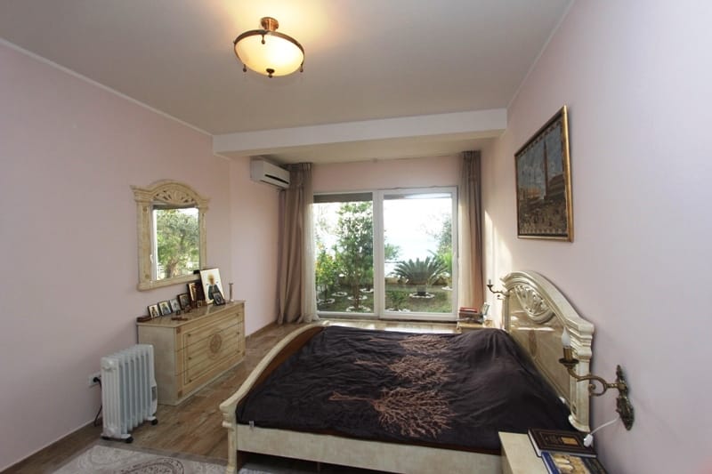 Cozy bedroom with a double bed and a garden view in a house for sale, Utjeha, Montenegro.