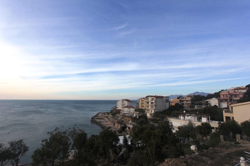 Panoramic view of the sea and the coastline of Utjeha, Montenegro, from the terrace of a private house surrounded by greenery.