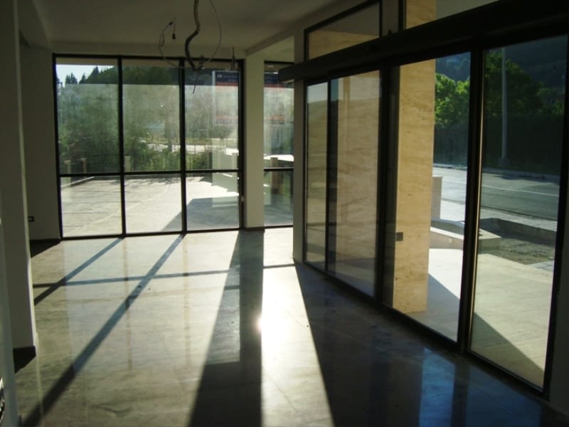 Commercial premises in Baošići, Montenegro: panoramic windows, marble floor and stone finishes, street view.