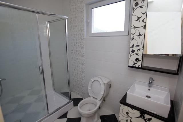 Modern bathroom with a shower cabin in a villa in Utjeha, Montenegro: stylish finishes and fixtures.