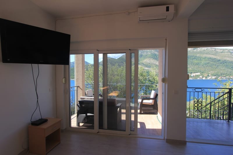 Living room with access to the terrace and panoramic sea view in Villa Lepetani, Montenegro.