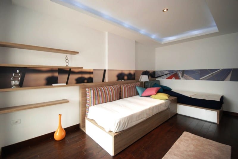 Modern bedroom with two beds in a residential complex in Kostanica, Montenegro: stylish interior and decor.