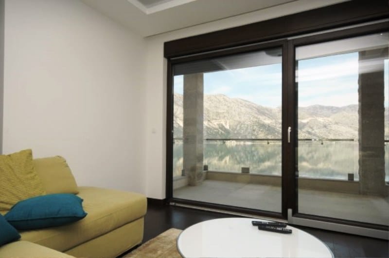 Living room with panoramic sea and mountain views in a residential complex, Kostanica, Montenegro: modern interior with a terrace.