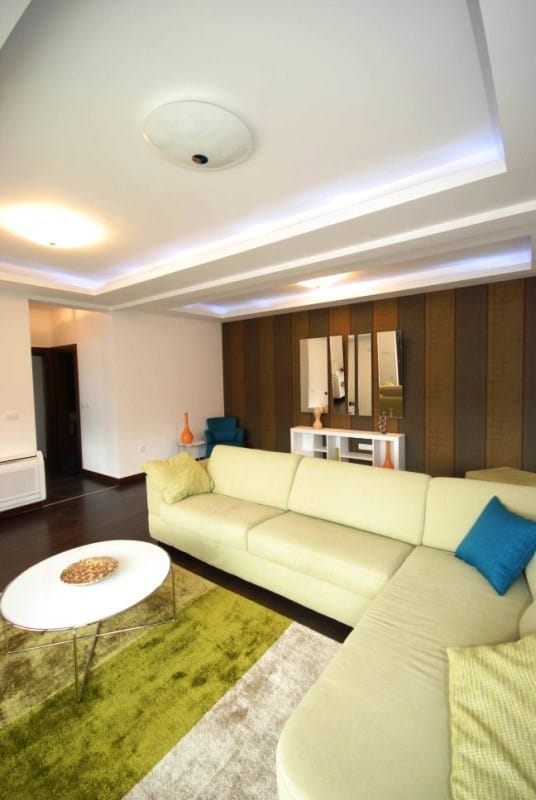 Modern living room with a corner sofa and ceiling lighting in a residential complex, Kostanica, Montenegro.