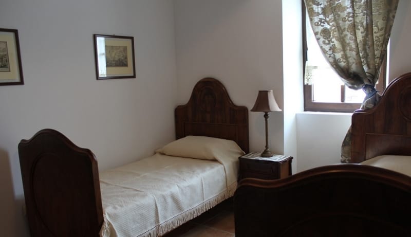 Bedroom with two wooden beds in a classic style in a house, town of Strp, Montenegro.