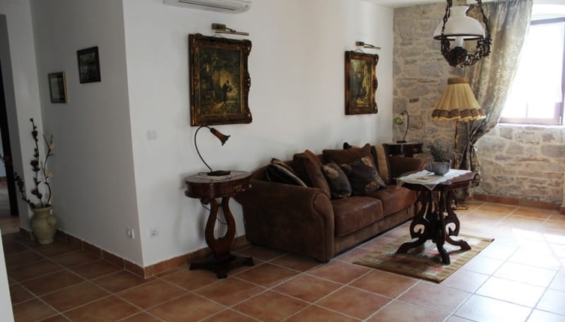 Living room in a house in Strp, Montenegro: classic furniture, stone finishes, a cozy interior with antique details.