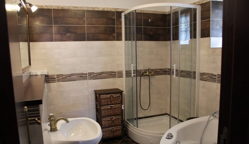 Modern bathroom with a shower cabin in a house for sale in Strp, Montenegro: tiles, plumbing fixtures, and furniture.