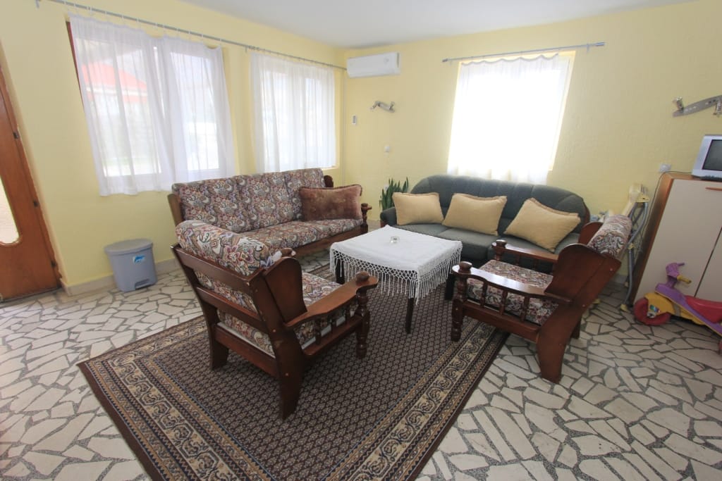 Living room with upholstered furniture and stone flooring in a house for sale in Radanovići, Montenegro.