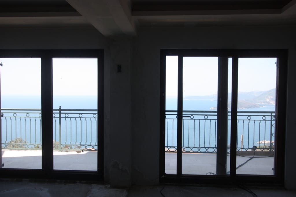 Living room with panoramic sea view and terrace in an under-construction villa, Blizikuće, Montenegro.