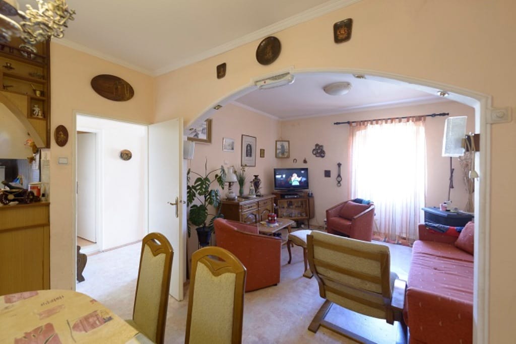 Cozy living room with soft furniture in a house for sale in Muo, Montenegro: view of the seating area and dining set.