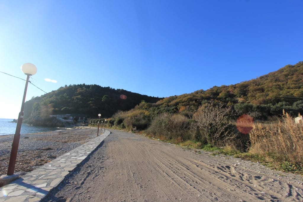 View of the sea coast and pedestrian path by the plot in Buljarica, Montenegro, with access to the sea and mountains.