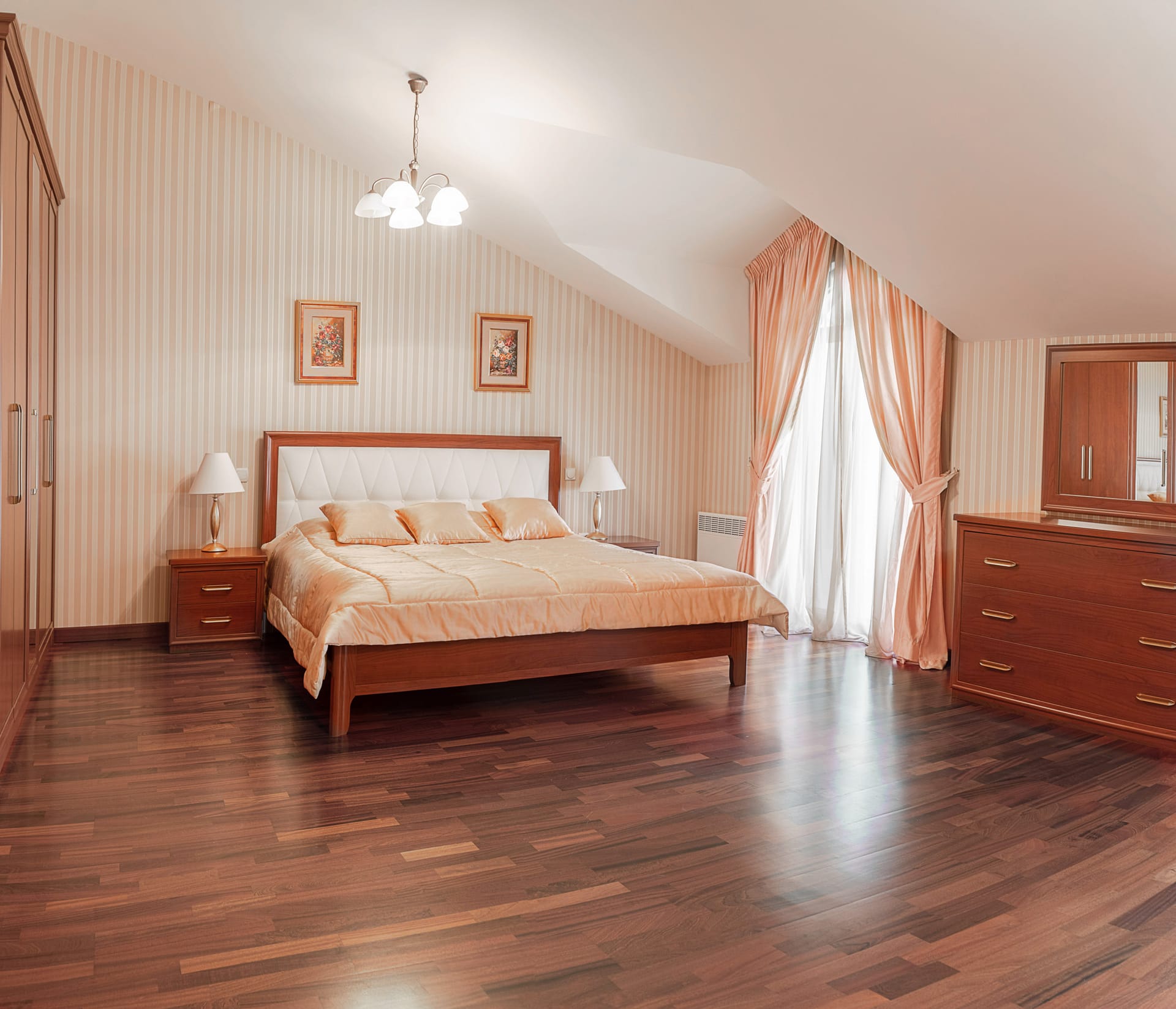 Cozy bedroom in a townhouse in Lastva, Montenegro: double bed, wooden furniture, parquet flooring, and skylight windows.