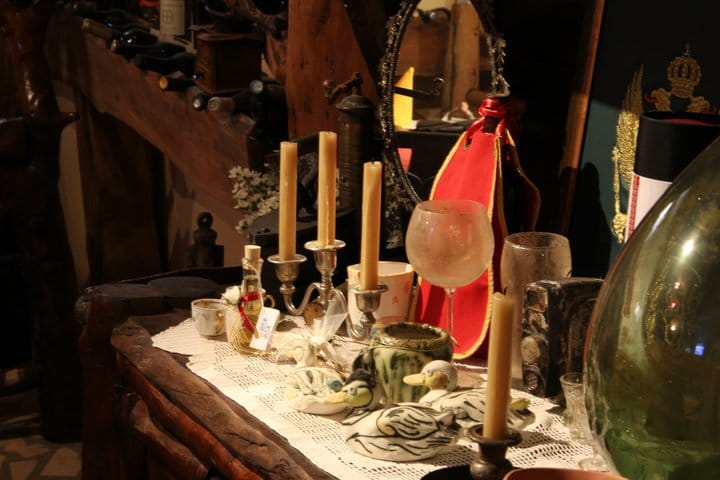 Restaurant interior in Virpazar, Montenegro: a vintage wooden table with decor, candles, and ethnic-style tableware.