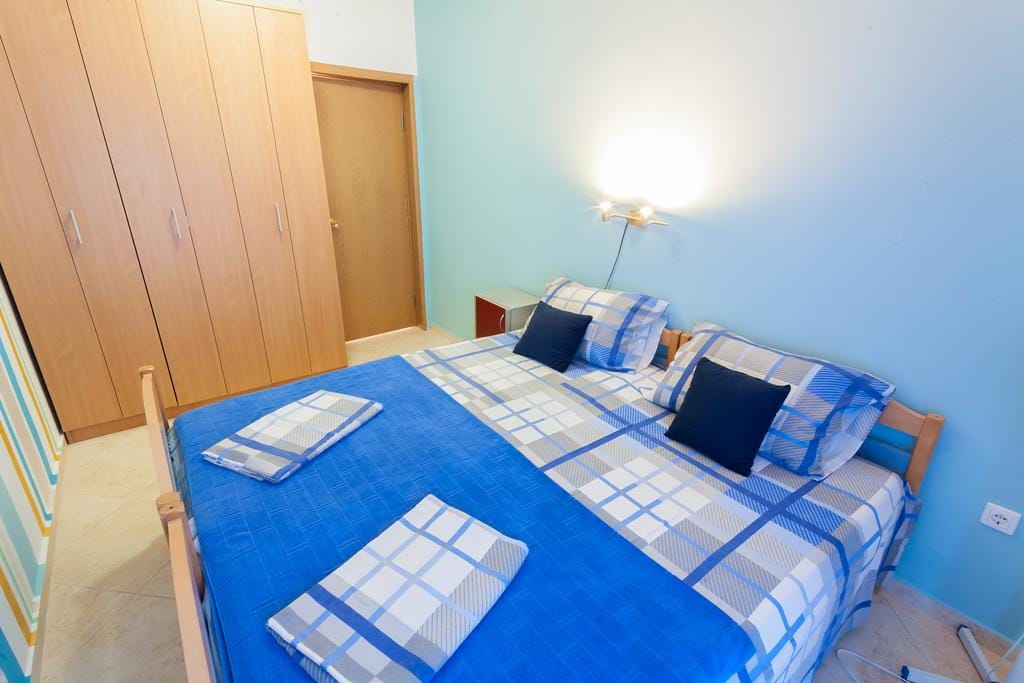 Cozy bedroom with a double bed and wardrobe in a house in Krimovice, Montenegro: interior with blue walls.